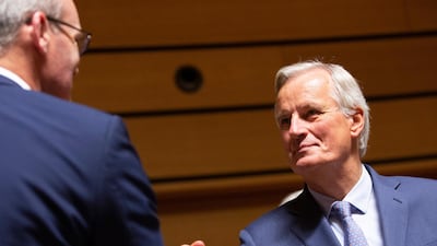 European Union chief Brexit negotiator Michel Barnier, right, shakes hands with Irish Foreign Minister Simon Coveney during a meeting of EU General Affairs ministers, Article 50, at the European Convention Center in Luxembourg, Tuesday, Oct. 15, 2019. European Union chief Brexit negotiator Michel Barnier is in Luxembourg on Tuesday to brief ministers on the state of play for Brexit. (AP Photo/Virginia Mayo)