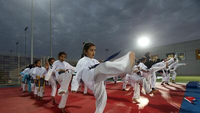 Wearing T-shirts emblazoned with the hashtag #uae_unites_us, schoolgirls from Al Ain Sports Games Company took part in a tae kwon do training session at Hazza bin Zayed Stadium organised by Al Ain Sports and Cultural Club. Satish Kumar / The National