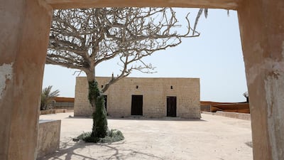 A tree sits in the centre of the courtyard to shade worshippers stood outside the small mosque. Pawan Singh / The National