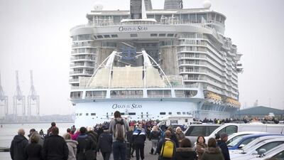 People gather on the waterfront to watch the world's largest cruise ship arrive in Southampton on October 15, 2014. Matt Cardy / Getty Images