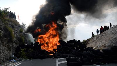 Demonstrators burn tyres during the protests. AFP