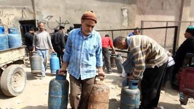 A man carries cooking gas cylinders at a selling depot in Cairo. There are no plans for reforming subsidies of fuel and food, which account for about 10 per cent of GDP.