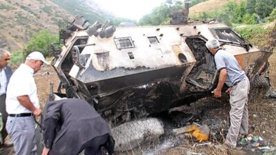 Kurdish people search for Turkish soldiers' bodies inside a destroyed army vehicle near Daglica District, in Hakkari city, southeast Turkey on September 7, 2015. The Turkish army said that 16 soldiers were killed and six wounded in an attack by Kurdish militants. Dicle News Agency/EPA