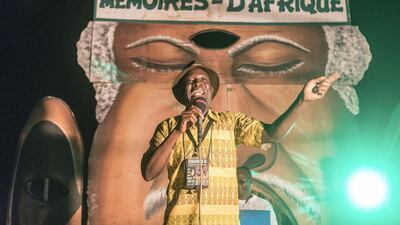 A Togolese professional storyteller speaks to the public gathered in Sainte Cecile Square in Cotonou during the African Memories Festival. AFP