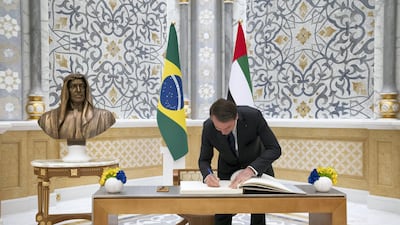 Jair Bolsonaro, President of Brazil, signs the visitor book during an official reception at Qasr Al Watan. Ministry of Presidential Affairs