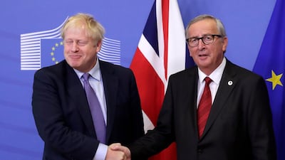British Prime Minister Boris Johnson and President of the European Comission Jean-Claude Juncker shake hands during a press conference on the Brexit deal. EPA