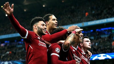 Liverpool's Roberto Firmino, second right, celebrates with his teammates after scoring the winning against Manchester City. EPA/Nigel Roddis