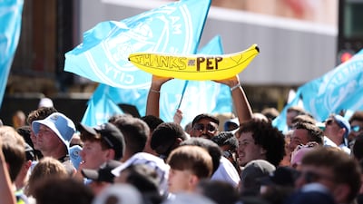 A fan holds up a sign for departing manager Pep Guardiola. PA