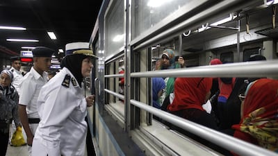 A female senior security officer speaks to women inside a female-only car at Al Shohadaa (Martyrs) metro station.