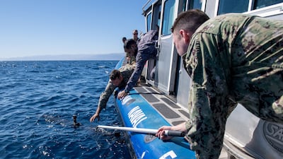 Sailors assigned to Task Force 59 and members of the Royal Jordanian Navy retrieve an unmanned undersea vehicle during an exercise in the Gulf of Aqaba on February 8, 2022. Reuters