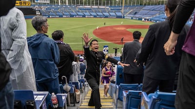 Meiji University 'oendan' whip up spectators during a university baseball game at Meiji Jingu Baseball Park in Tokyo