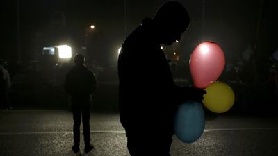 A man holds balloons in the colours of the Romanian flag in Bucharest, Romania. Inquam Photos / Octav Ganea / via Reuters