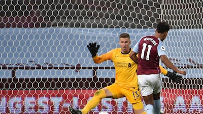 Liverpool's goalkeeper Adrian, left, makes a save from Ollie Watkins. AP