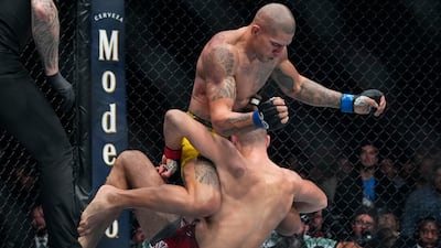 Alex Pereira knocks down Jiri Prochazka during the second round of their light heavyweight title bout. AP