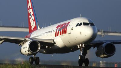 An aircraft of the Brazilian airline TAM prepares to take off at the Santos Dumont Airport in Rio de Janeiro. Qatar Airways has bought a stake in the plane's operator, Latam. Pilar Olivares / Reuters