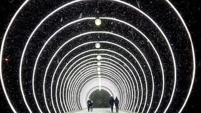 People walk under the major snowfall in central Moscow. The temperature in Russian capital dropped down to -2 degrees Celsius but due the wind and humidity condition it felt like -6 degrees. Kirill KUDRYAVTSEV / AFP