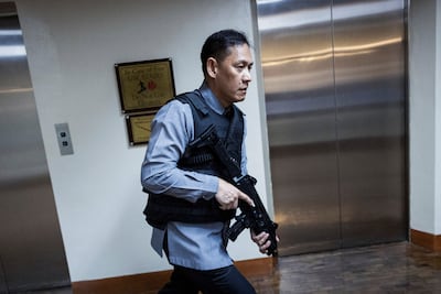 An armed member of Senate security after the gunshots were heard. Reuters