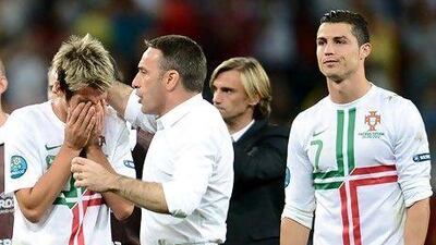 Coach Paulo Bento consoles his Portuguese players.