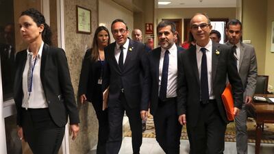 Josep Rull, Jordi Sanchez, and Jordi Turull leave after processing their parliamentary acts at Spanish Parliament, in Madrid, Spain. EPA