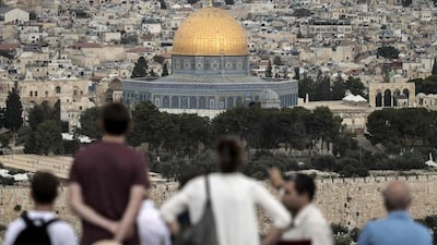 Tourists visit the Mount of Olives in East Jerusalem, overlooking the Old City and the Dome of the Rock at the Al Aqsa Mosque compound. AFP