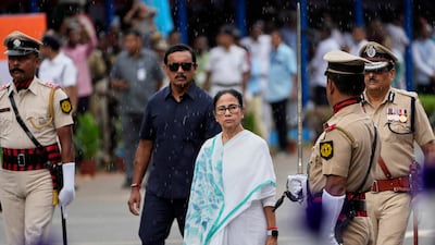 West Bengal state Chief Minister Mamata Banerjee, centre, inspects a guard of honor during Independence Day celebrations in Kolkata. AP