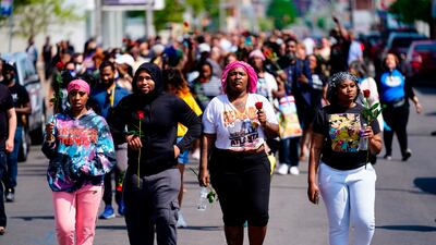 People march to the scene of the shooting in Buffalo. AP