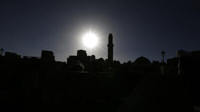 Yemenis walk past historic buildings in the old quarter of Sanaa, Yemen, on February 28, 2018. Yahya Arhab / EPA