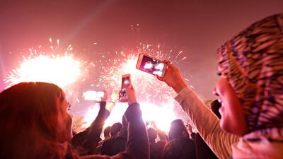 People record fireworks on mobile phones during a New Year celebrations at the Waterway in Cairo, Egypt. Reuters
