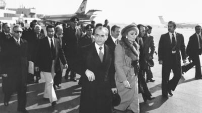 FILE - In this Jan. 16, 1979 file photo, Shah Mohammad Reza Pahlavi and Empress Farah walk on the tarmac at Mehrabad Airport in Tehran, Iran, to board a plane to leave the country. Forty years ago, Iran's ruling shah left his nation for the last time and an Islamic Revolution overthrew the vestiges of his caretaker government. The effects of the 1979 revolution, including the takeover of the U.S. Embassy in Tehran and ensuing hostage crisis, reverberate through decades of tense relations between Iran and America. (AP Photo, File)