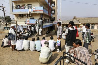 Customers wait in line to withdraw money from a Central Bank of India branch in Dhadgaon village, Maharashtra. . Photographer: Bloomberg