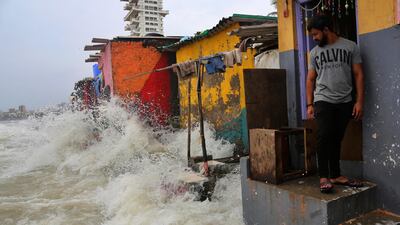 An Indian man stands near his house as waves caused by high tide hits the huts on the shore of the Arabian Sea in Mumbai, India, Wednesday, July 3, 2019. AP Photo