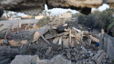 Palestinians inspect the site of an Israeli strike on a house, amid the ongoing conflict between Israel and Hamas, in Deir Al-Balah in the central Gaza Strip. Reuters