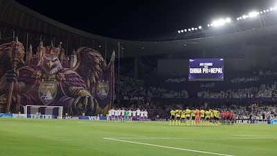 The teams line-up before the match. Chris Whiteoak / The National
