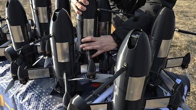 An employee of Ukrainian SkyFall company conducts checks P1-Sun interceptor drones before a test flight in March. Photo: AFP