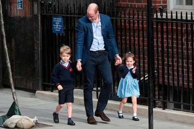 Princess Charlotte of Cambridge waves at the media as she is led in with her brother Prince George of Cambridge, to visit their new-born brother. Daniel Leal-Olivas / AFP