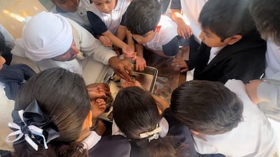 Children learn about the region's pearl heritage and traditions at Abu Dhabi Pearls Centre. The National