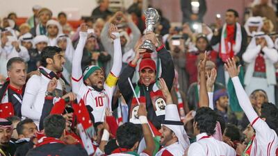 UAE coach Mahdi Ali, centre, lifts the Gulf Cup trophy after his side's victory in the 2013 tournament. Fadi Al-Assad / Reuters / January 18, 2013