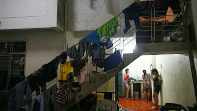 Women wash inside a warehouse where they are sleeping, on the outskirts of Cucuta, Colombia. Reuters