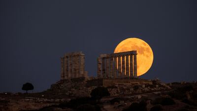 Moon rises behind the Temple of Poseidon in Sounion, Greece , July 20, 2024. REUTERS / Stelios Misinas