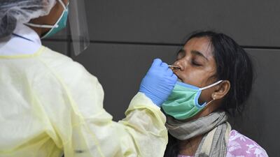 A member of an Indian medical team is tested upon the team's arrival at Dubai International Airport to help with the coronavirus (COVID-19) pandemic. AFP
