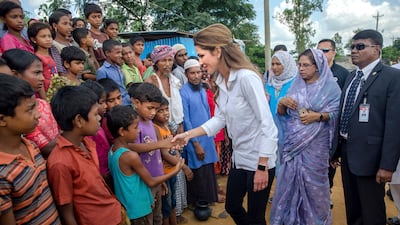 Queen Rania of Jordan shakes hands with Rohingya Muslim children, who have crossed over from Myanmar into Bangladesh, during her visit to Kutupalong refugee camp, Bangladesh. Dar Yasin / AP Photo