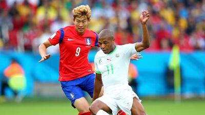 Yacine Brahimi of Algeria and Son Heung-Min of South Korea compete for the ball during their match on Sunday at the 2014 World Cup. Ian Walton / Getty Images