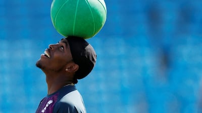 England's Jofra Archer balances a ball on his head. Reuters