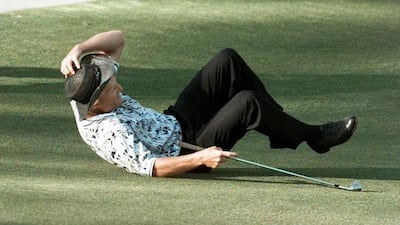 Greg Norman falls to the ground after missing his shot for an eagle on the 1th hole during the final round of the 1996 Masters. Dave Martin / AP Photo