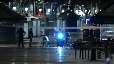 Policemen and forensic units work at the area of the attack. Josep Lago / AFP Photo