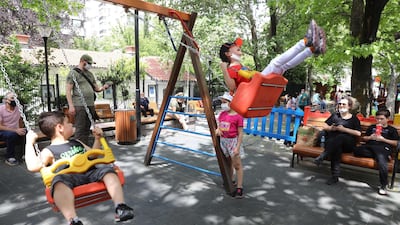 Children play at Kugulu Park in Ankara as Turkey allowed children under 14 to leave their homes within walking distance and wearing masks between 11 am and 3 pm. AFP