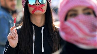 An Iraqi university student with mouth taped attends a protest in central Baghdad, Iraq. EPA