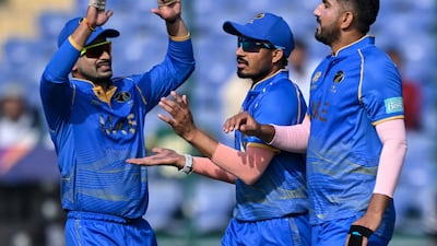 UAE's Junaid Siddique, right, finished with five wickets on Friday. AFP