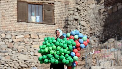 An Afghan man carries plastic pots for sale in the city of Kabul, Afghanistan. AP
