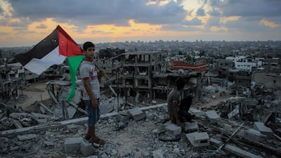 Gazan children look at what remains of their home after Israel launched Operation Protective Edge last summer, in which more than 2,000 Palestinians were killed. Rex Shutterstock / DDP